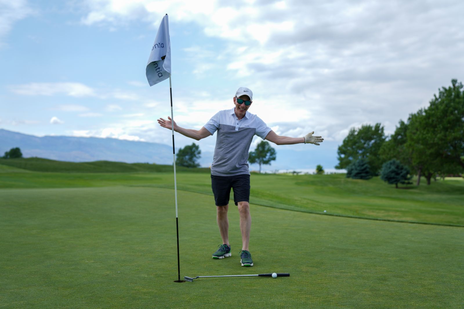 Board Chair Dan Price celebrates not having to putt out